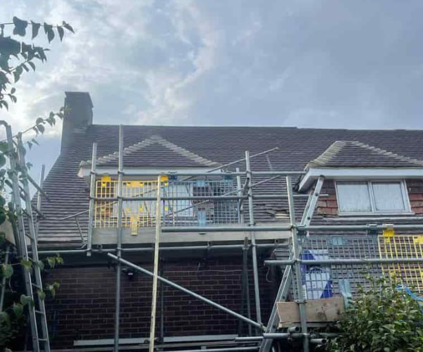 This is a photo of a roof with two dormers that is having some damaged tiles replaced. Works carried out by ES Roofing Adwick Le Street